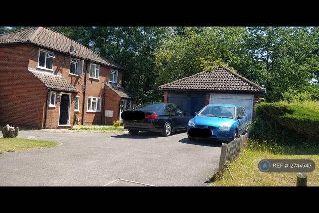 White Garage And Two Car Parkings In The Front