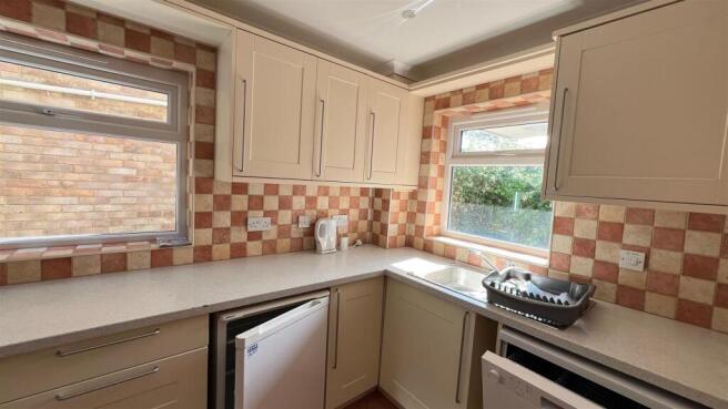 Bright fitted kitchen with double windows...
