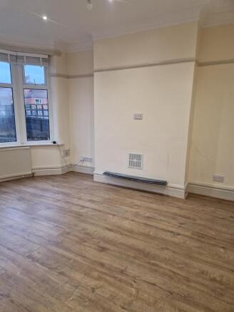 Bright space with wood floors and bay window...