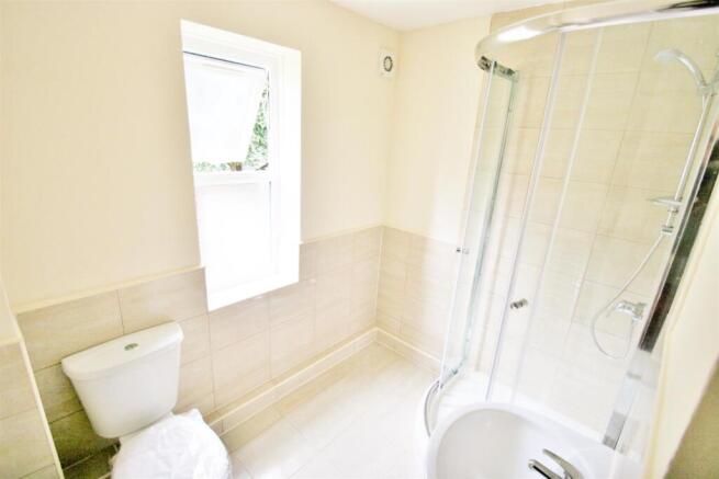 Bright and clean bathroom featuring a modern sh...
