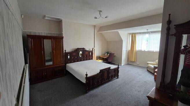 Spacious master bedroom with desk and wardrobe...