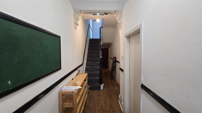 Bright and tidy hallway with stairs...