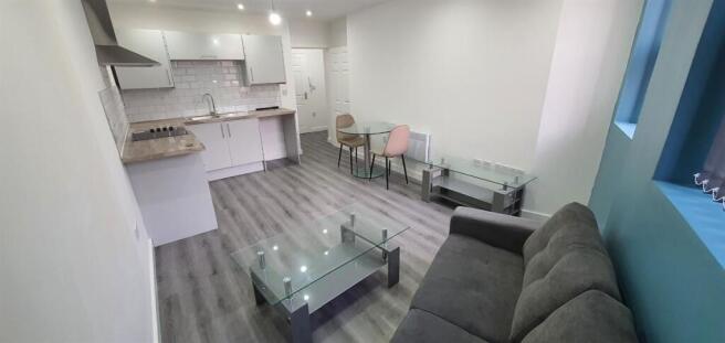 Bright, modern living room with an open-plan ki...