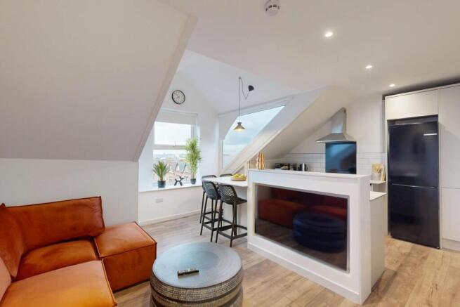 Bright and modern living area featuring a comfo...