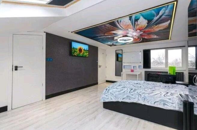 Bright, contemporary master bedroom with a deco...