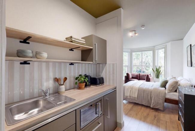 Modern studio kitchen with stylish open shelvin...