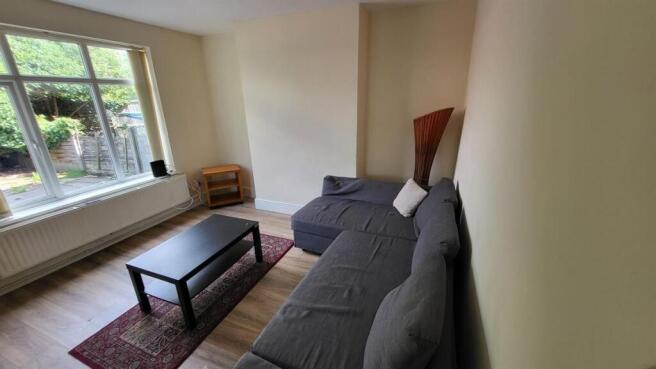 Bright living room with a large front window, c...