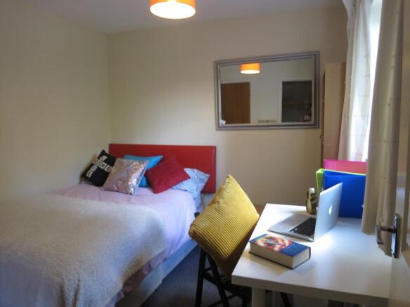 Bright, neatly presented bedroom with a comfort...