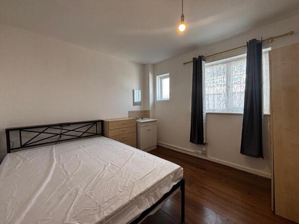 Bright double bedroom with modern wooden floors...