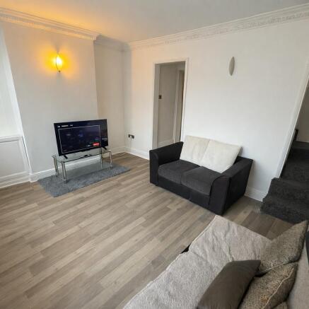 Bright, modern living room with light wood floo...