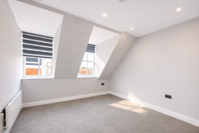 Modern bedroom with sloping roofline