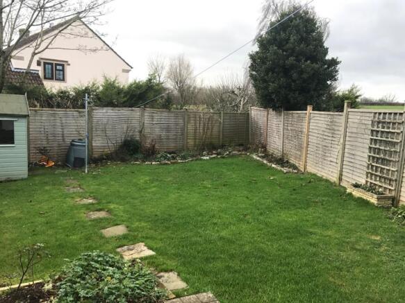 Enclosed garden with a shed.