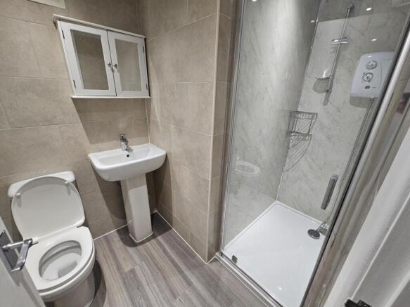 A modern, tidy bathroom with a large shower enc...