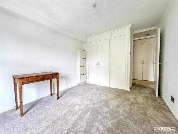 Bright bedroom with built-in storage and desk...