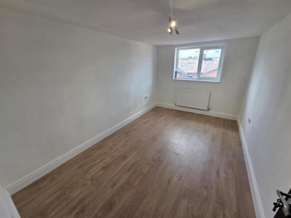Bright, spacious room with modern wood flooring...