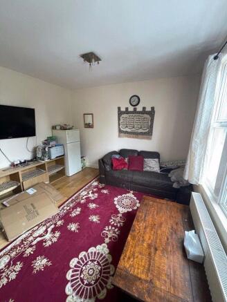 Bright living room with a large patterned rug, ...