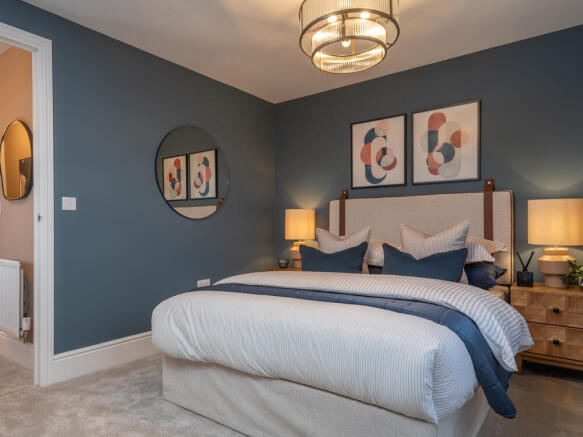 Bedroom 2 featuring a double bed and bedside tables, plenty of space with warm blue tones.