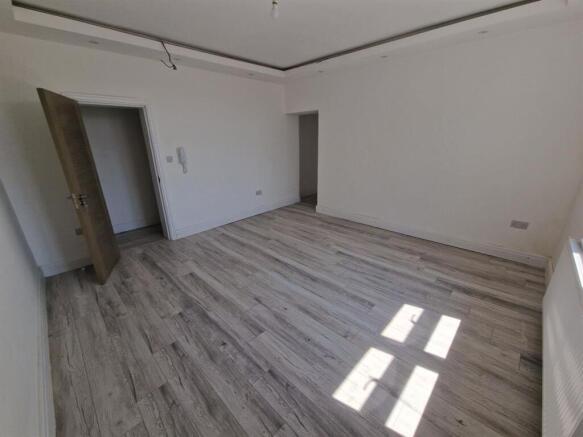 Bright, spacious room with modern wood flooring...