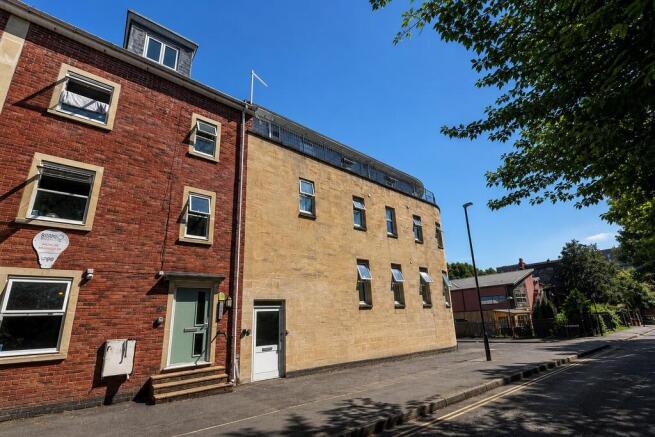 Modern brick building under a clear blue sky...