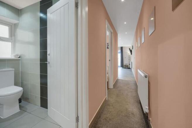 Bright, modern hallway with warm pastel walls...