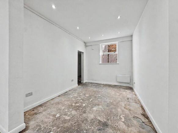 Bright, open room with spotlights and neutral w...