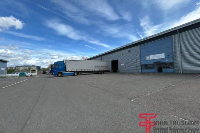 Industrial warehouse with parked truck.png