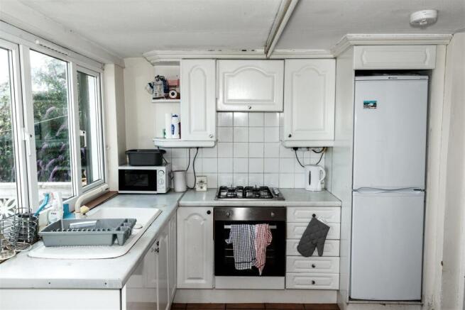 Bright kitchen with modern appliances and windo...