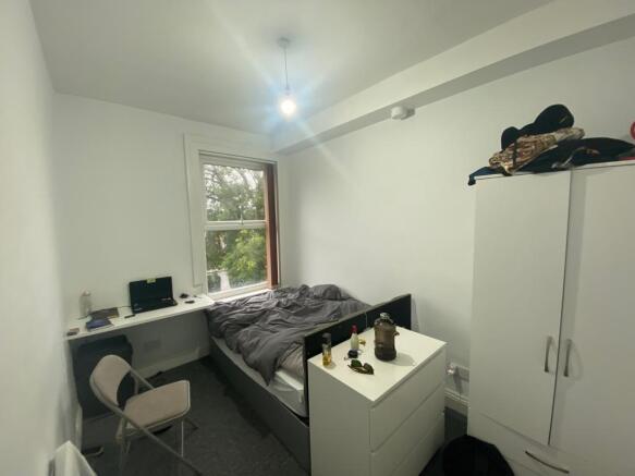 Bright bedroom with integrated desk and storage...