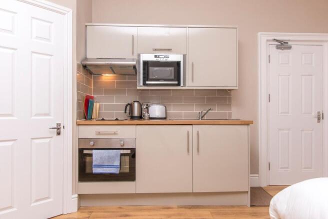 Modern kitchenette with sleek integrated applia...