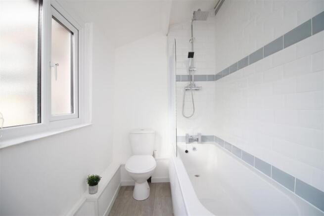 Bright bathroom with modern tub and large windo...