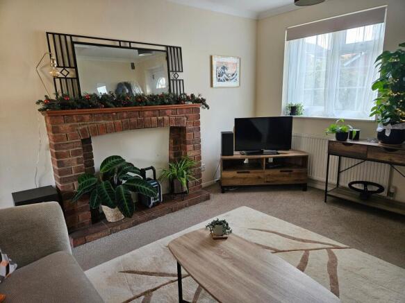 Bright, neatly styled living room with a decora...