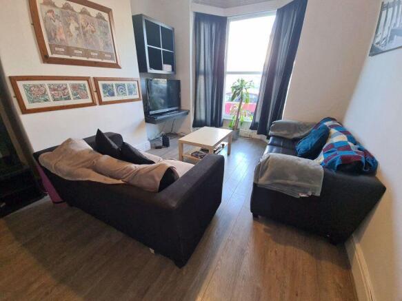 A cozy and well-kept living room featuring two ...