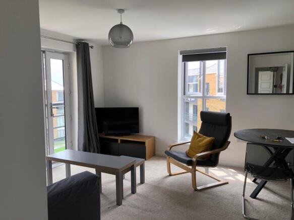 A spacious and inviting large modern living roo...