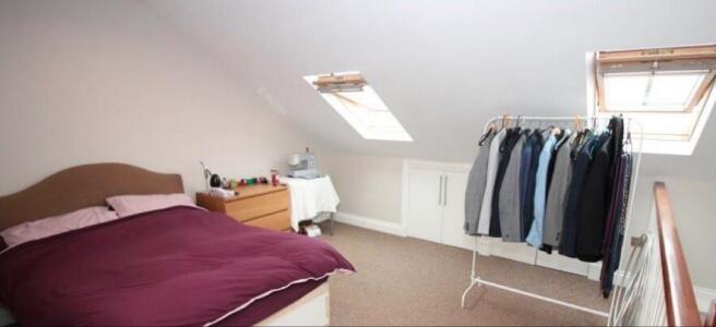 Bright attic master bedroom with two skylight w...