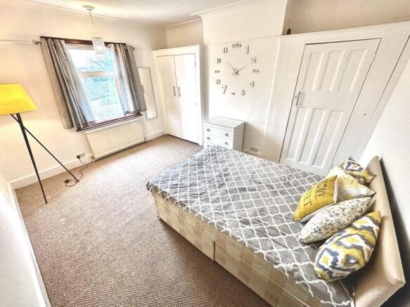 Bright and welcoming double bedroom featuring a...