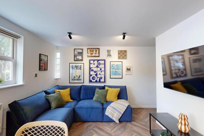Bright, stylish living room with a comfy blue L...