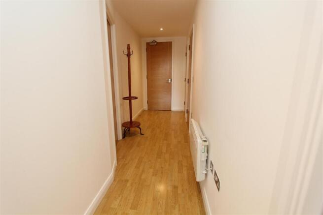 Bright modern hallway with sleek wood flooring...