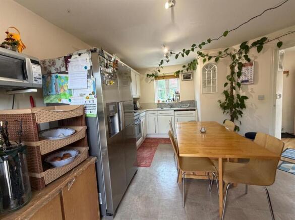 Bright kitchen with large dining table and plan...