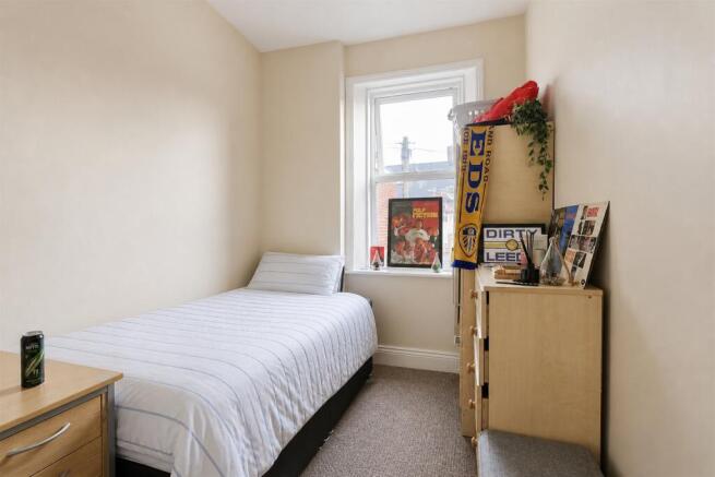 Bright and cozy bedroom with ample storage spac...
