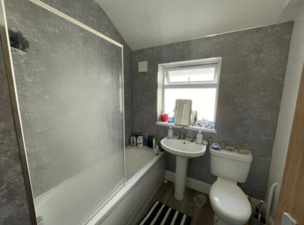 Modern bathroom with bathtub and shower screen,...