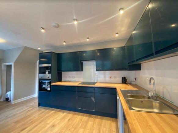 A modern and clean kitchen with blue cabinets a...