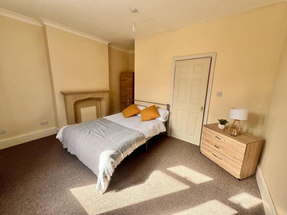 A bright and inviting double bedroom featuring ...