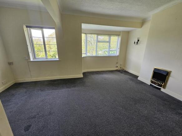 A spacious living room featuring large windows ...