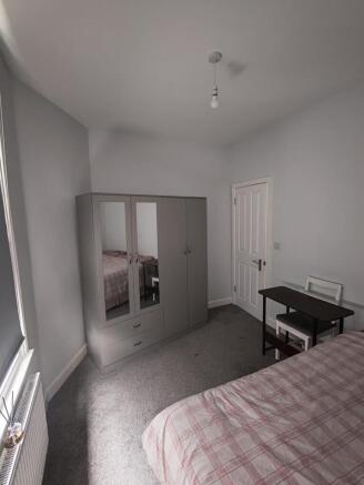 Bright bedroom with ample storage and desk spac...