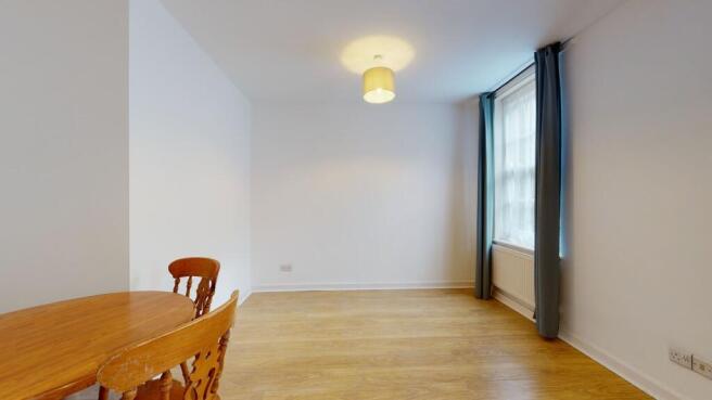Bright, airy living space with wood flooring...