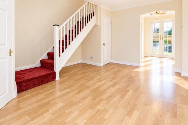 Sunlit Hallway with Burgundy Staircase