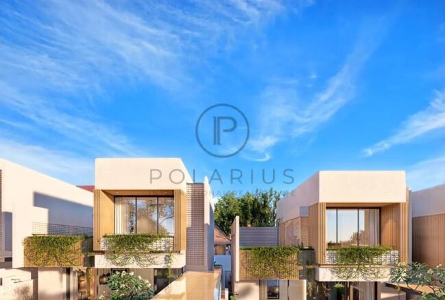 Modern townhouse buildings under a clear blue sky,