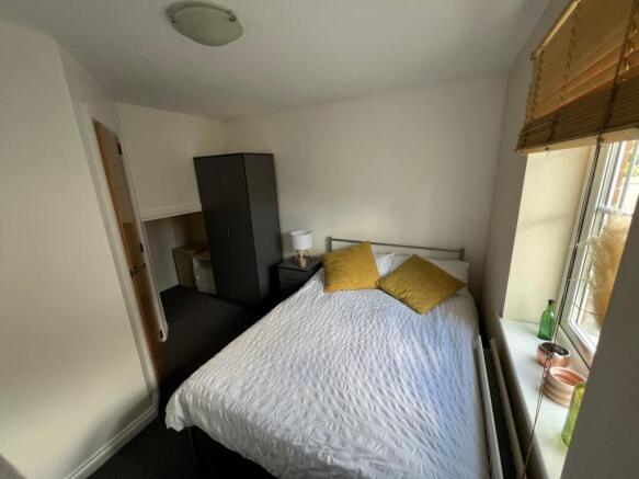 Bright double bedroom featuring a comfortable d...