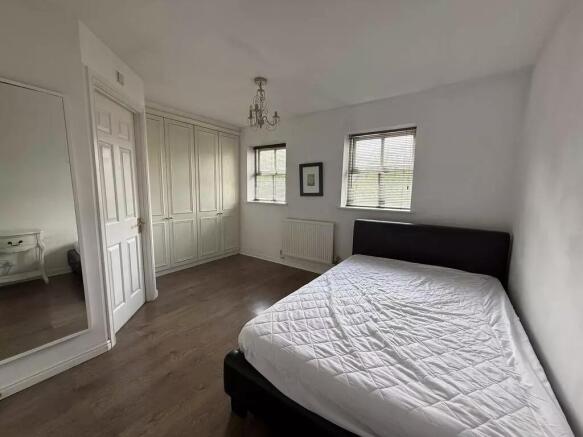 Bright master bedroom with fitted wardrobes...