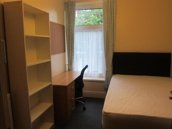 Bright bedroom with ample storage and desk area...